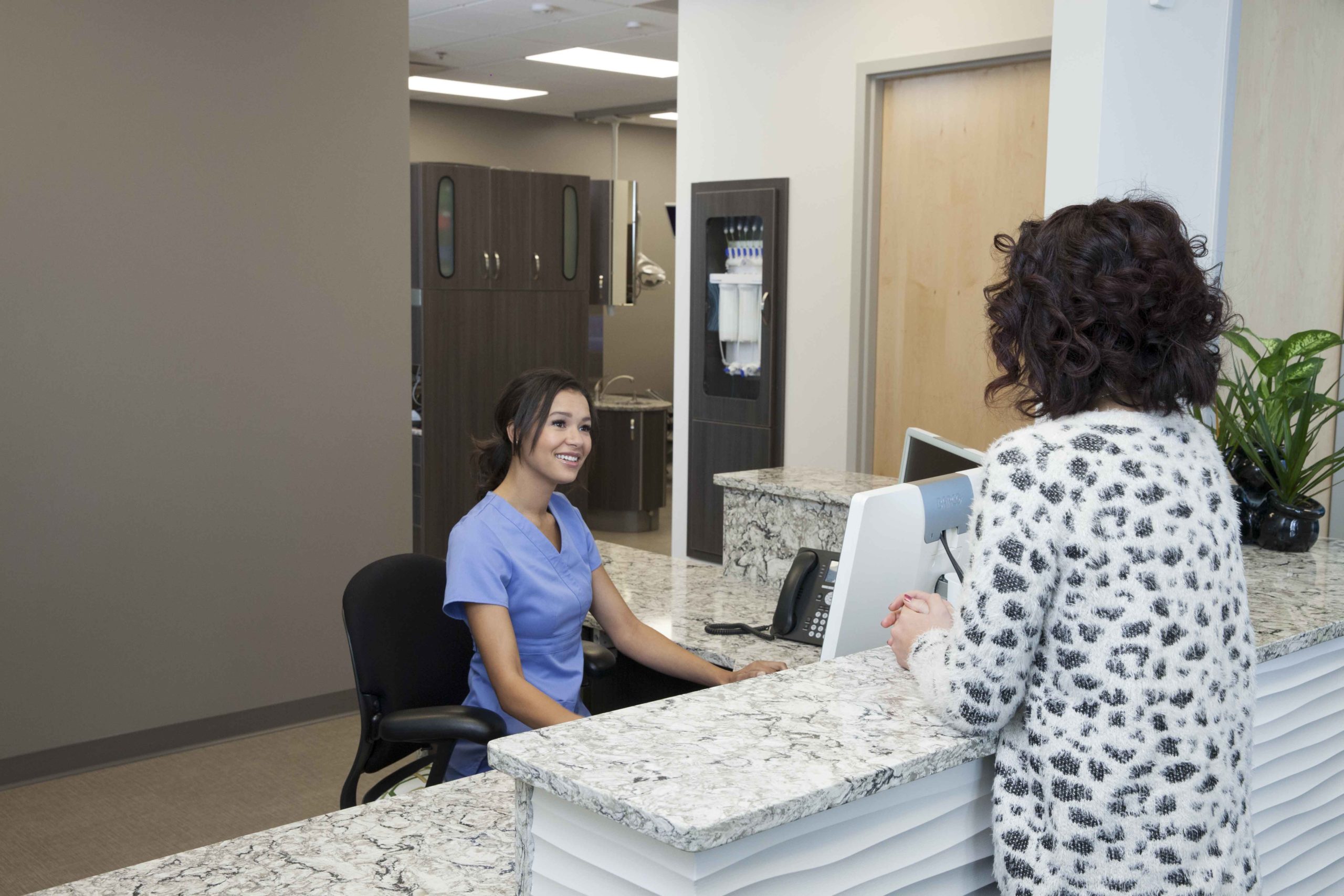 Patient talking with front desk